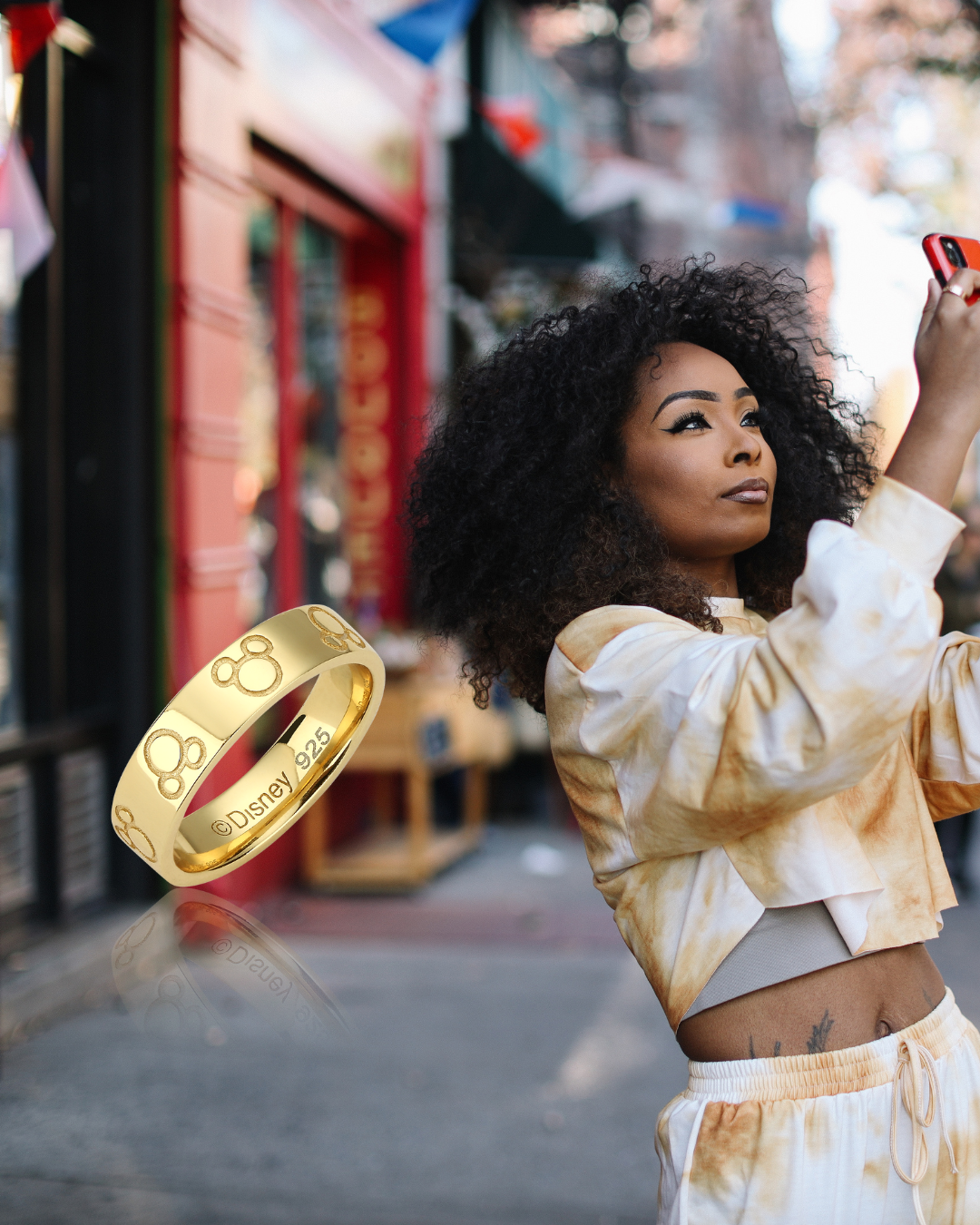 Model_Holding_Red_Phone_taking_photo_on_street_with_yellow_Gold_Disney_Couture_kingdom_mickey_Mouse_Ring